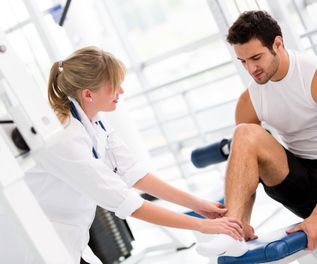 Injured man at the gym feeling pain in his ankle